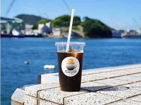 イメージ：海を背景にしてコーヒーが置かれている様子